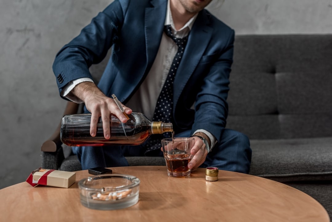 61566baba398bf5469bb5813 crello 187670502 stock photo cropped shot alcohol addicted businessman p 1080
