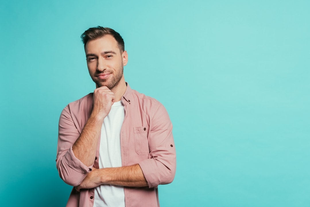615b668669c1a25ddcc5e963 crello 329263032 stock photo cheerful handsome man thinking looking p 1080