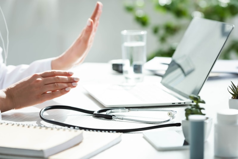 6160a6738e80ec5d5cc2067a crello 319583114 stock photo cropped view doctor having online p 800