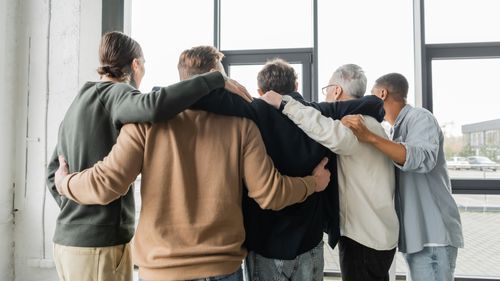 A group of men rejoicing after completing ASIC Recovery's drug addiction treatment program in DFW 