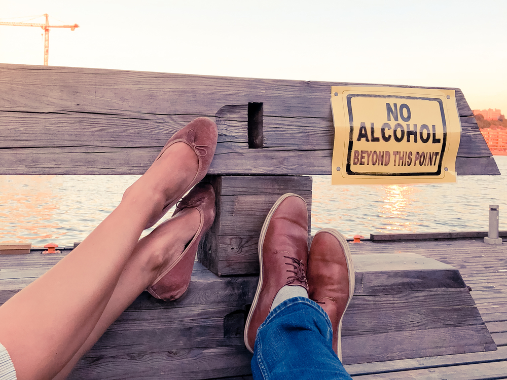 Woman in her husbands arms knowing she needs help to overcome her alcohol addiction